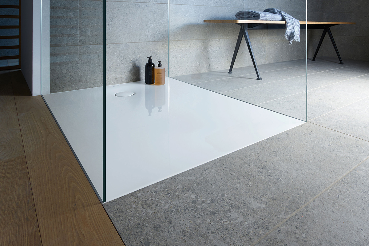Flush-fitted shower tray with grey tiles and wood-effect flooring, one of our family bathroom ideas