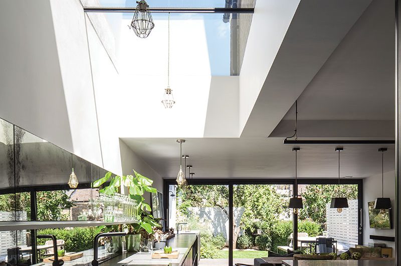An industrial-style kitchen extension with a large run of cabinetry on one wall