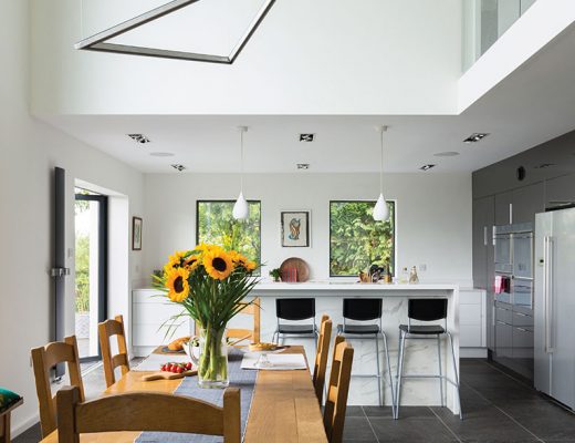 double-height kitchen with mezzanine in this house renovation