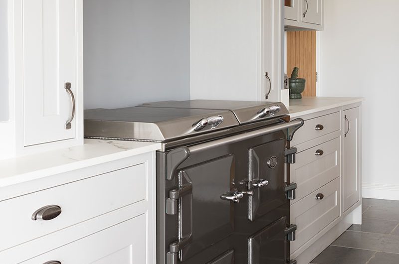 white painted cabinetry by range cooker