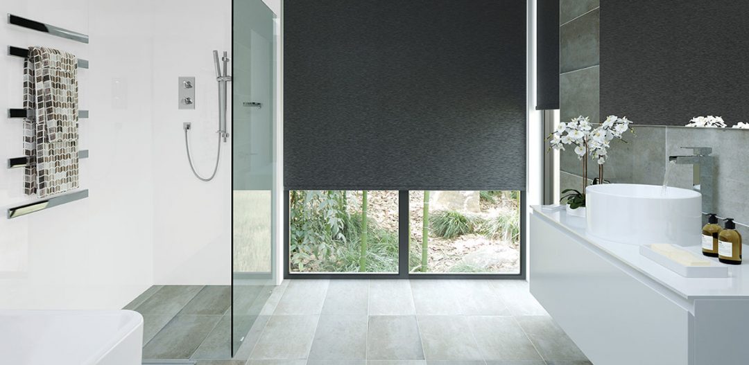 Bright wetroom with large grey blinds and wood effect floor illustrating a feature on how to create a wetroom bathroom