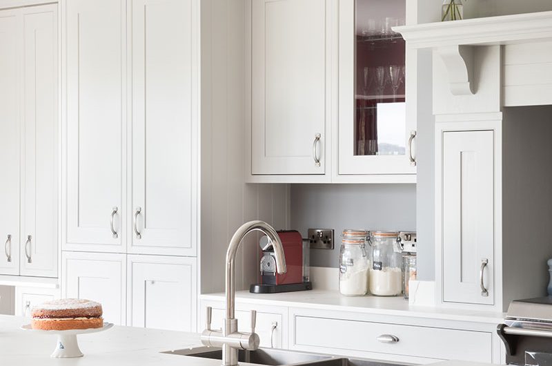 red kitchen island with oak worktop overhang