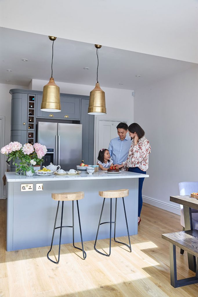 the family altogether at home in their grey kitchen