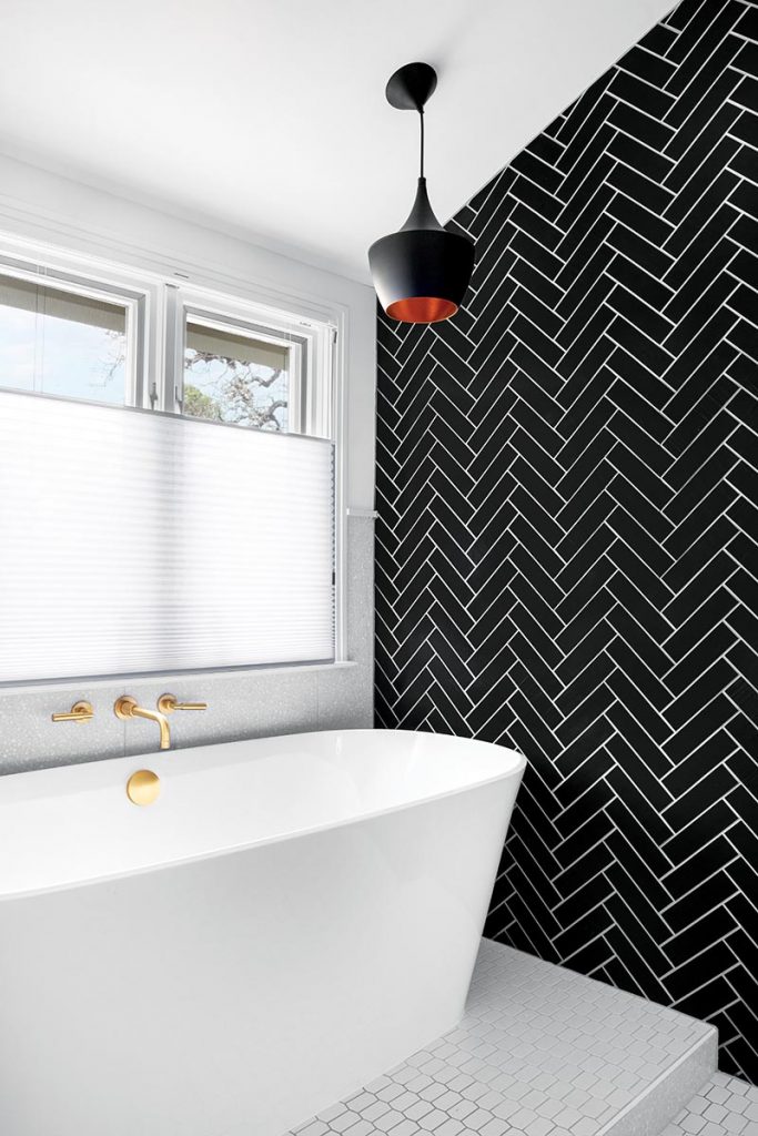 a tub next to geometrical tiles