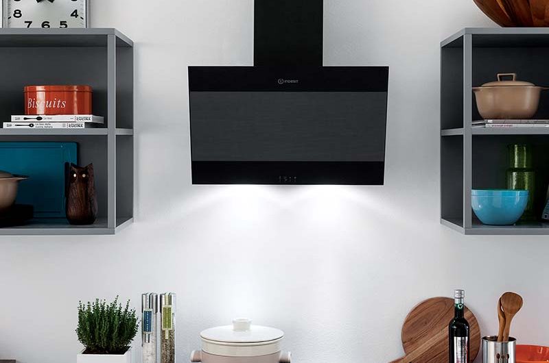 a walnut kitchen with grey worktop with lots of accessories on it