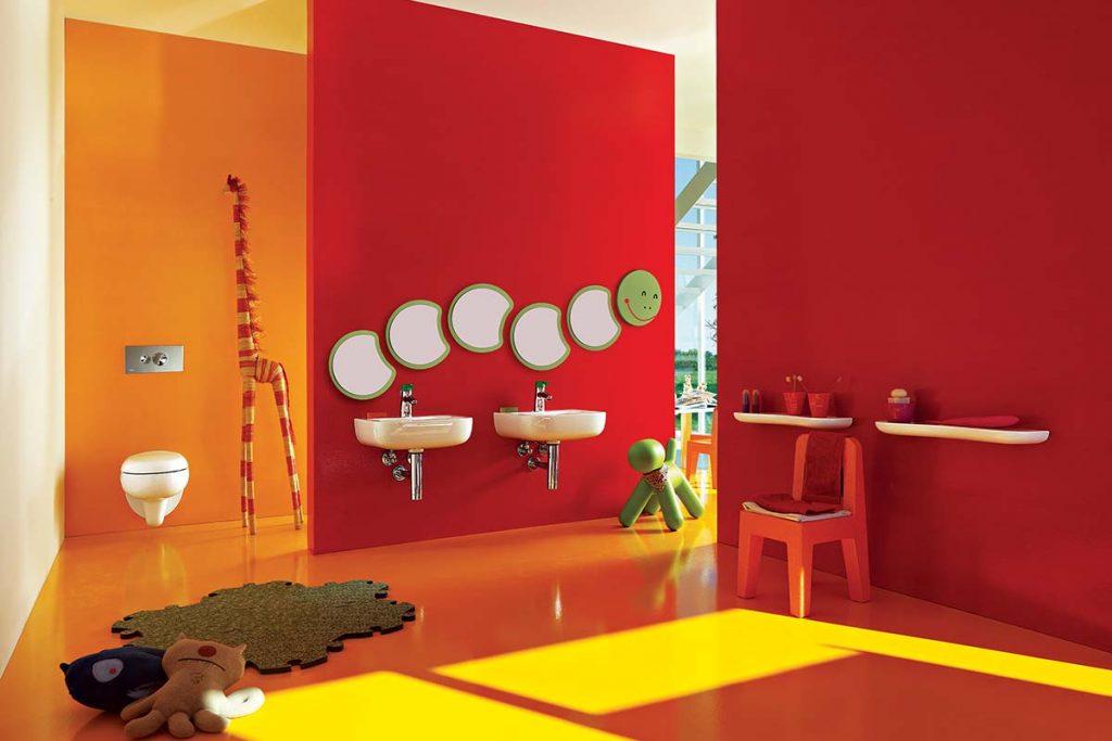 a bright red and orange room designed for kids with a caterpillar mirror on the wall and a tall giraffe