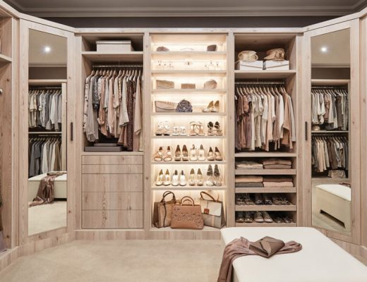 a cream walk-in wardrobe with light wood and shoes and bags hanging up inside it for a feature on how to design a dressing room