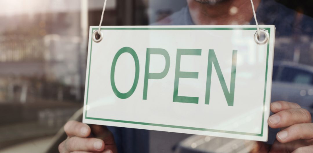 an 'open' sign on a shop to signal that kitchen and bathroom showrooms are open again