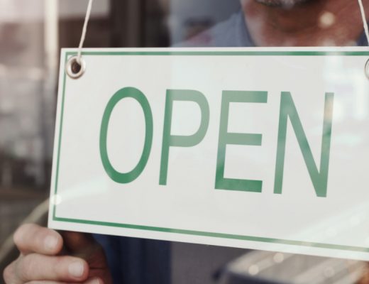 an 'open' sign on a shop to signal that kitchen and bathroom showrooms are open again