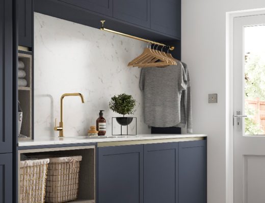 a laundry room featuring navy cabinetry and a wink with brass tap