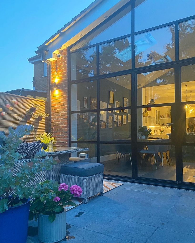 the outside of a kitchen extension with steel framed glazing