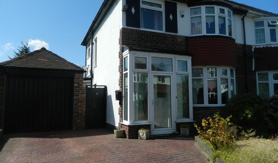 the outside of a red brick semi-detached house