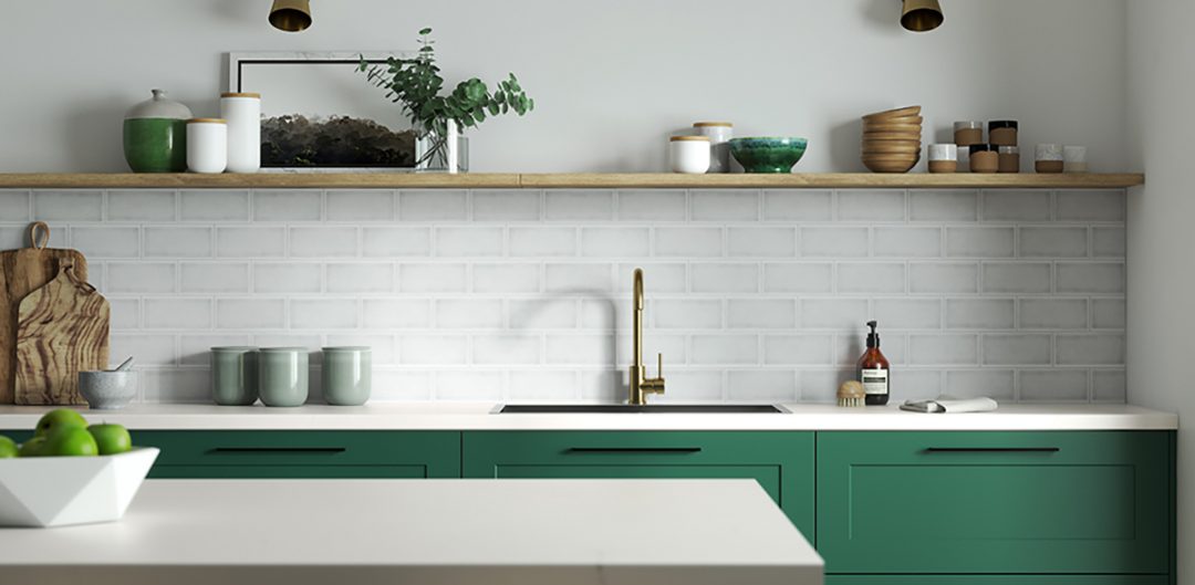 a jade green kitchen with white tiles and brass hardware to illustrate the question of how much a kitchen costs
