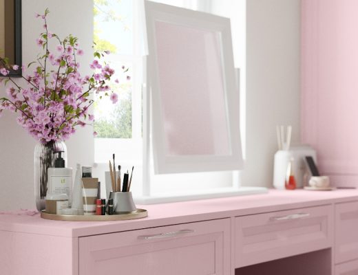 a pastel pink dressing table with a white mirror on top
