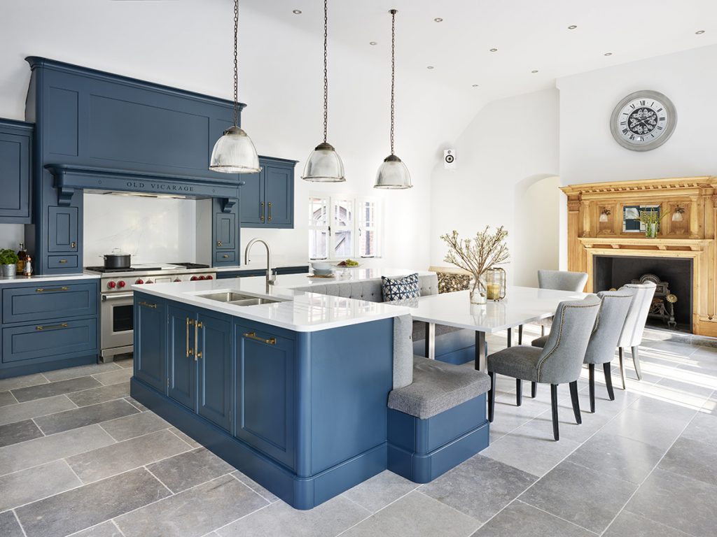 three pendant lights over a white marble island with a sink and brass tap