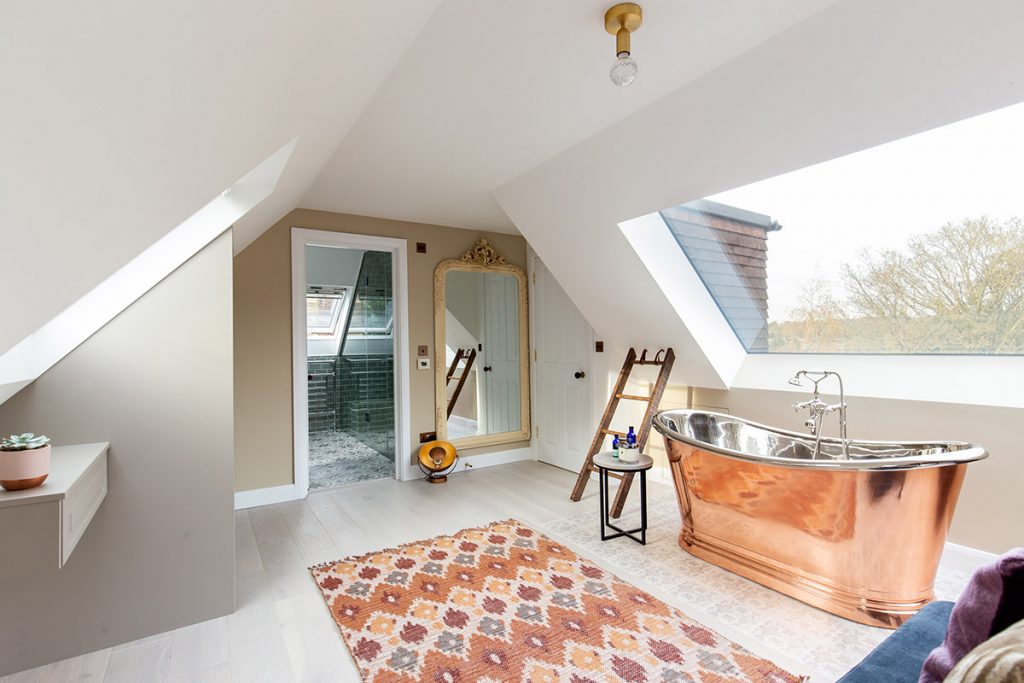 a bedroom with a bath under the window