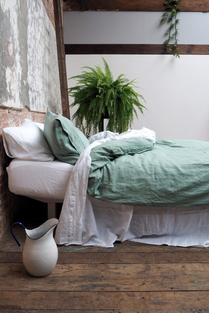bedlinen next to a fern