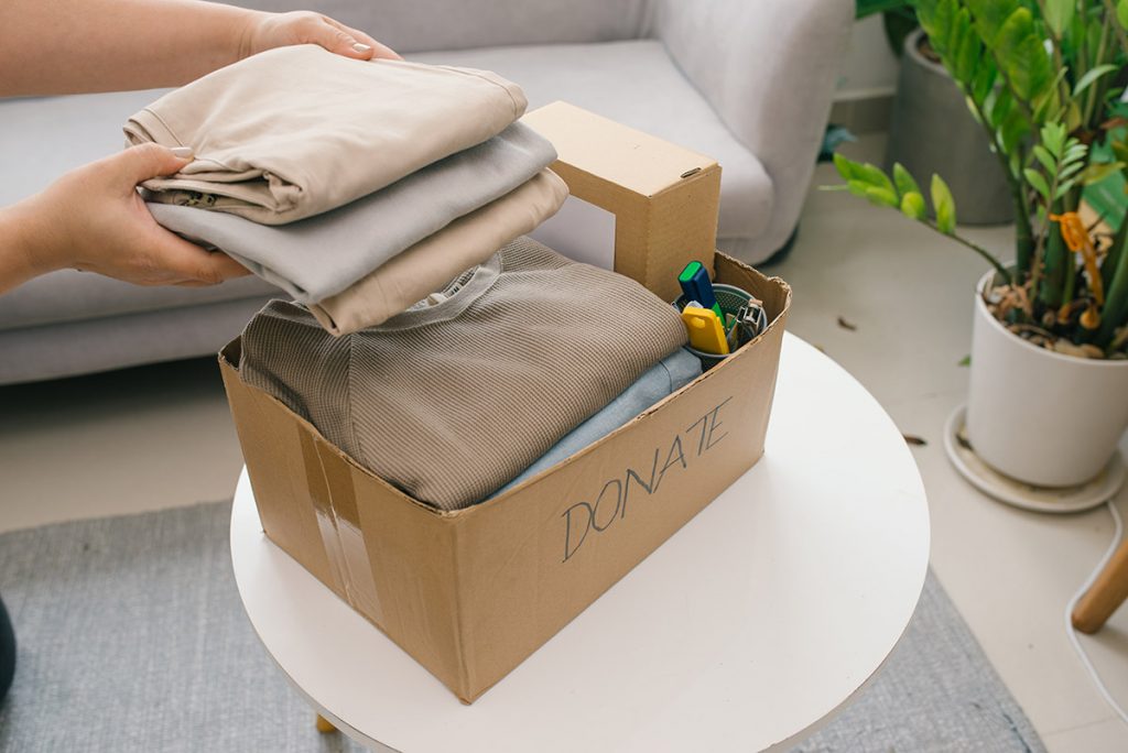 woman donating clothes before house move